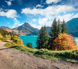 Fototapeta na wymiar Gorgeous morning view of Roselend lake/Lac de Roselend under the deep blue sky. Sunny autumn scene of Auvergne-Rhone-Alpes, France, Europe. Beauty of nature concept background.