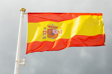 flag of Spain on a flagstuff in front of the sky