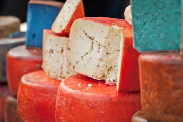 Different types of cheese on the table. Many cheese is sold at an agricultural fair. Natural home product.