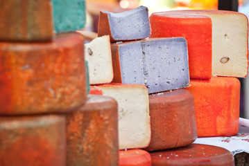 Different types of cheese on the table. Many cheese is sold at an agricultural fair. Natural home product.