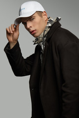 Medium close-up shot of a short-haired European man dressed in a dazzle hooded top, a black jacket...