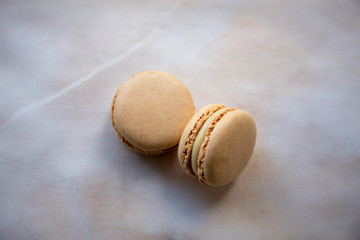 Creamy colour macaroons on the paper