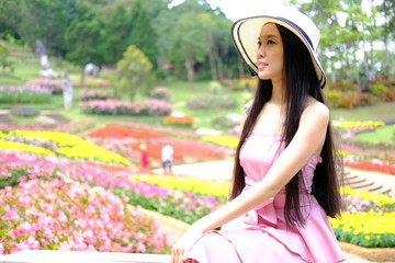 beautiful young woman relaxing in flower garden