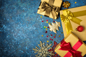 Golden gift boxes with shiny satin bows and christmas decorations