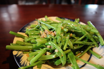 Vietnamese food called morning glory stir fry with garlic. A popular vegetable dish in Vietnam.
