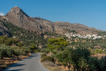 Mountain village of  Pefki seen from Agios Stefanos road, Crete, Greece. September 2019.  The mountainside ancient village of Agios Stefanos one of the oldest in Crete.