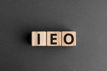 IEO - acronym from wooden blocks with letters, abbreviation IEO Initial Exchange Offerings concept,...