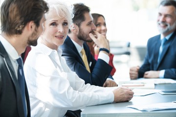 Portrait of smiling business woman looking at camera.