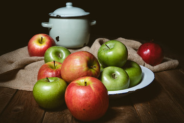 Ripe red and green apples on table close up