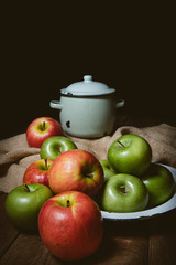 Ripe red and green apples on table close up