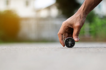 A man holding compass on road texture background, journey of life concept