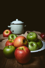 Ripe red and green apples on table close up