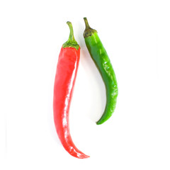 Two hot chili peppers of red and green color close-up on a white background