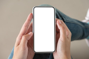 Woman holding and using smart phone with blank white screen