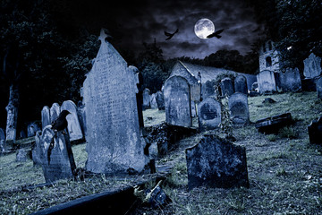 old graveyard with ancient tombstones grave stone and old church front of full moon black raven...