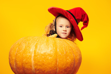 girl hiding behind the pumpkin