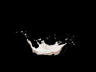 Splashes of milk or white liquid on a black background