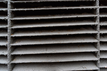 Worn metal curve grille of wide strips