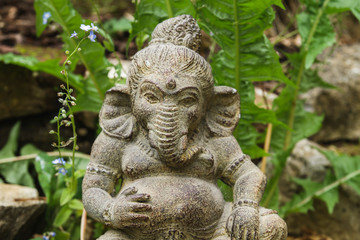 Fototapeta na wymiar Ganesha stone statue in a garden