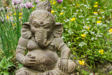 Fototapeta na wymiar Lord ganesh ornamental stone statue in a garden