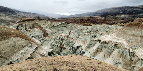 Breathtaking views of the grey-blue badlands and the John Day river valley from the Blue Basin Overlook Trail at the John Day Fossil Beds in Kimberly Oregon
