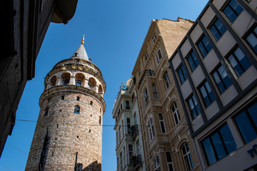 Fototapeta premium Istanbul, Turkey: the Galata Tower, a medieval stone tower built by Genoese in 1348 in the Karakoy quarter, a cone-capped cylinder dominating the skyline and offering panoramic vista of the city