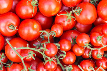 Cherry tomatoes in old wooden tray.