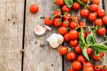 Fresh cherry tomatoes on a wooden table.