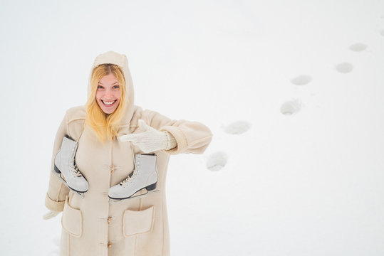 Funny face. Young woman at winter. Beautiful woman walking in winter park and feeling wonderful. Winter holiday. Happy young woman walking in winter time.