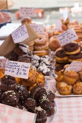 A market stall with different kind of muffins in a marketplace 