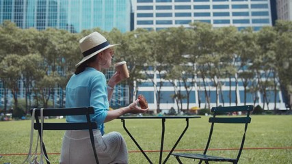 Young girl having breakfast in the park