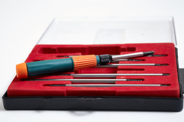 Metallic and plastic industrial screwdriver kit or set with various screwdriver head type such as torque and cross type isolated on white background