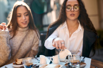 two attractive women sitting in the street cafe