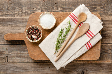 Cooking table with vintage cutting board, spoons and spices