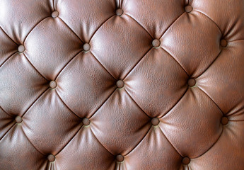 Naklejka premium Detail of an old vintage brown couch with buttons