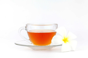 Cup of tea with plumeria flowers on white background