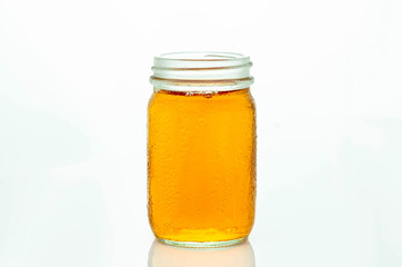 Tea in glass bottles isolated on a white background