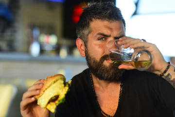 Happy elegant man drinking beer. Portrait of handsome young man tasting a draft beer. Enjoy in pub.