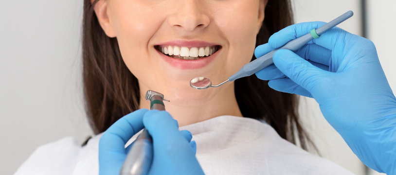Cropped image of smiling woman attenting dental clinic