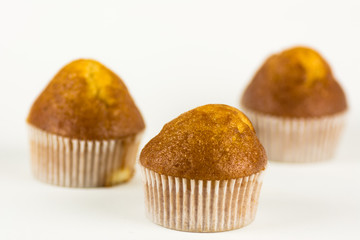 Three delicious muffins on a white background.