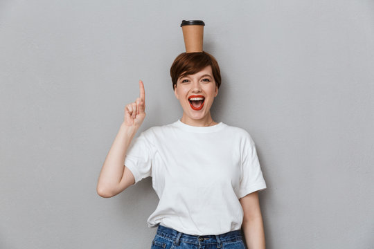 Image of gorgeous woman laughing with takeaway coffee cup on her head