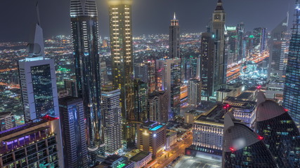 Skyline of the buildings of Sheikh Zayed Road and DIFC aerial night timelapse in Dubai, UAE.