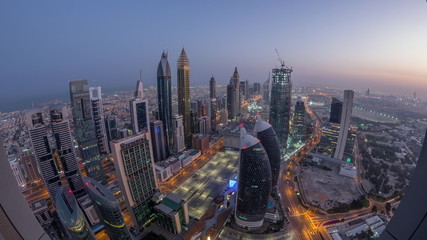 Naklejka premium Skyline budynków Sheikh Zayed Road i DIFC antena nocna na dzień timelapse w Dubaju, ZEA.