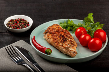 Tasty grilled chicken with fresh tomatoes on a dish