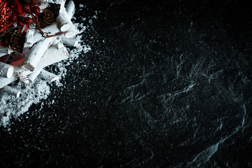 Christmas Decoration with Snow on Black Background with Copy Space