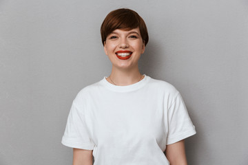 Image of joyful brunette woman wearing casual t-shirt smiling at camera