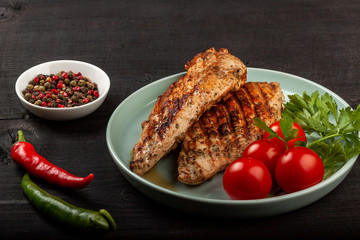 Tasty grilled chicken with fresh tomatoes on a dish