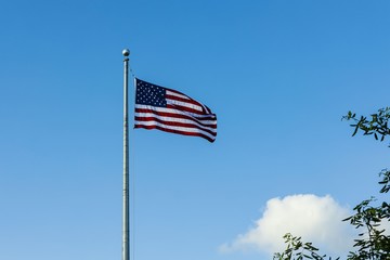 Beautiful view of American flag blue sky with white clouds background.