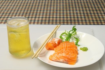 salmon sashimi on plate with beer