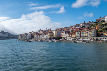 Obraz premium View of Porto across the Douro River from the opposite river bank with historic centre in the distance as the river snakes away